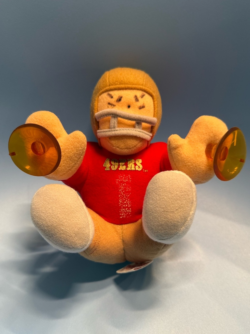 A vintage San Francisco 49ers NFL plush doll featuring suction cups on its hands
